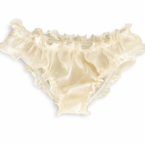 Cream-colored silk underwear on a white background